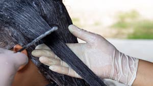 A hairdresser relaxing someones hair